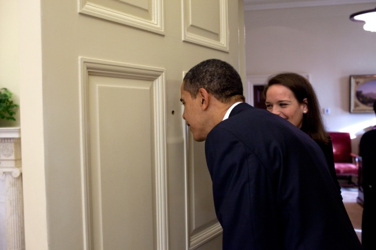 President Obama looking through the door of the Oval Office